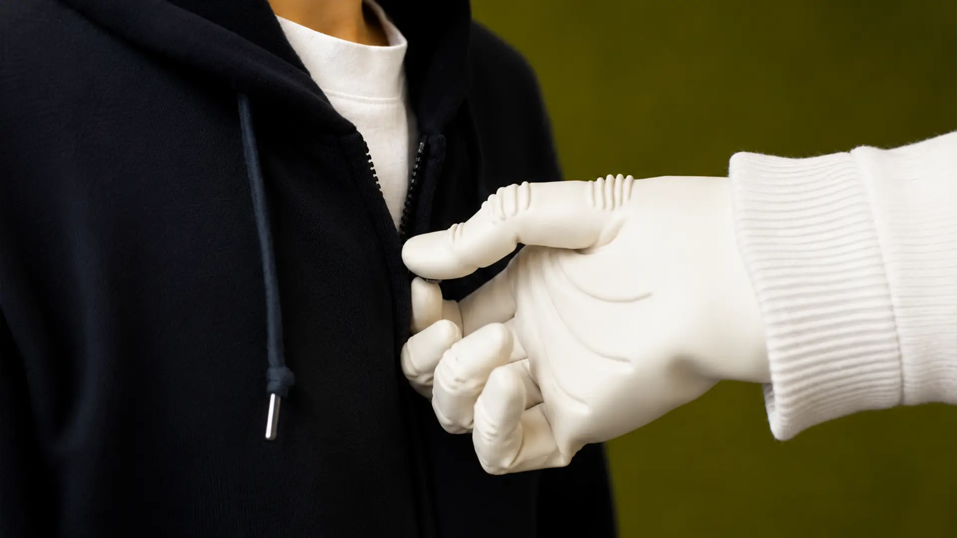1X NEO hands operating a zipper