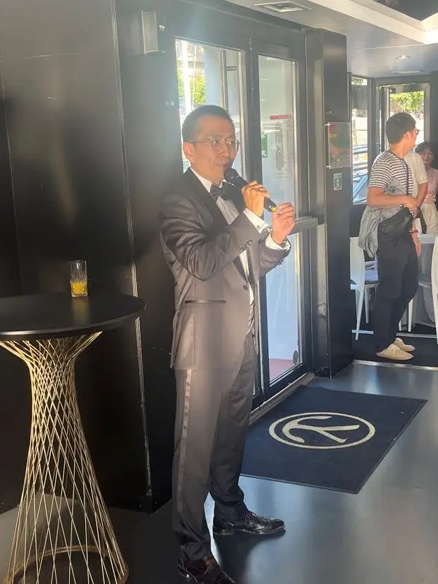 Steve Xie Lightwheel founder and CEO speaking aboard a boat on the Seine in Paris