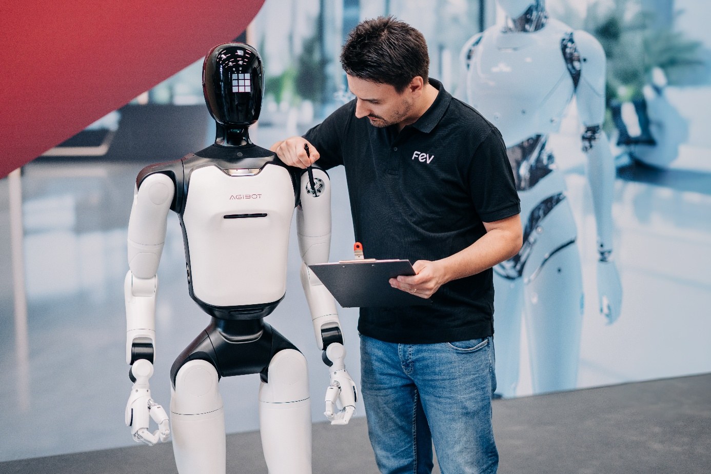 FEV team member inspecting an AgiBot humanoid robot